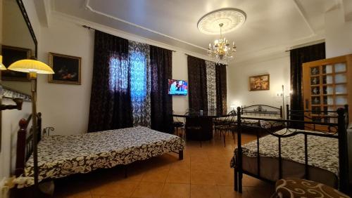 a bedroom with two beds and a chandelier at Villas de Nazare in Maceira