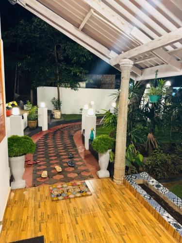 a walkway in the middle of a room with plants at Trinco Chill Zone Hostel in Trincomalee