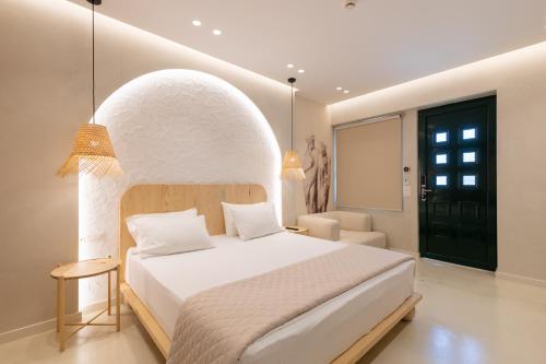 a bedroom with a large white bed with an arched ceiling at Dimitri Hotel in Himare
