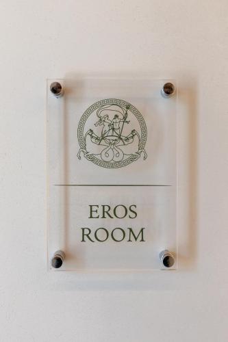 a close up of a cross room sign on a wall at Dimitri Hotel in Himare