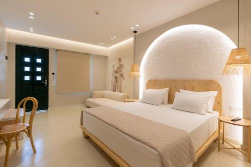 a bedroom with a large bed and a table at Dimitri Hotel in Himare