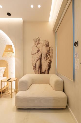 a living room with a statue of two women at Dimitri Hotel in Himare