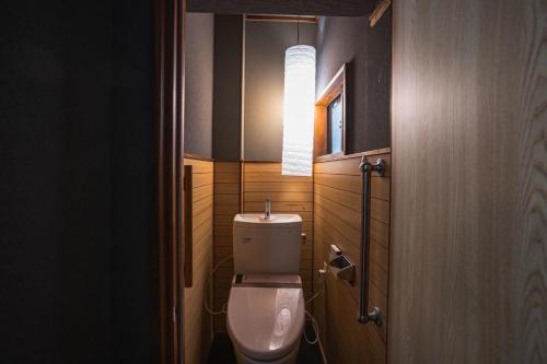 a bathroom with a toilet and a mirror at 6-minute walk to Tokyo Skytree Up to 6 people 68 sqm fully renovated direct access to Asakusa, Shibuya, Narita Airport, and Haneda Airport in Tokyo