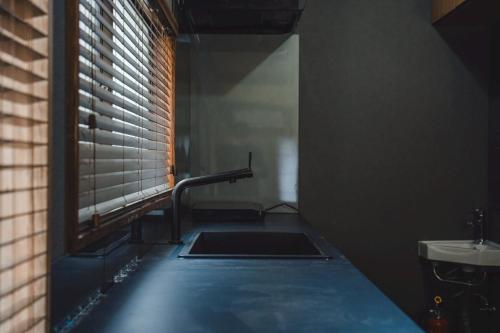 a bathroom with a sink and a window and a sink at 6-minute walk to Tokyo Skytree Up to 6 people 68 sqm fully renovated direct access to Asakusa, Shibuya, Narita Airport, and Haneda Airport in Tokyo