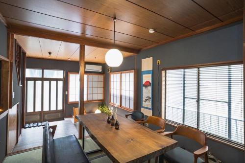 a dining room with a wooden table and chairs at 6-minute walk to Tokyo Skytree Up to 6 people 68 sqm fully renovated direct access to Asakusa, Shibuya, Narita Airport, and Haneda Airport in Tokyo
