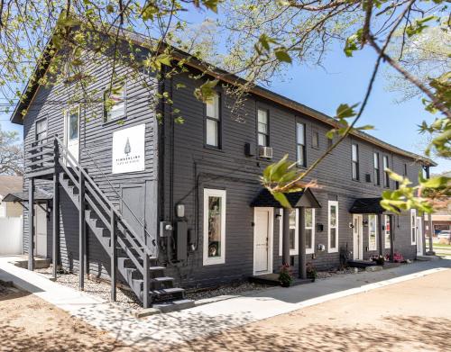 a black building with a staircase in front of it at Juniper at Timberline Flats in Traverse City