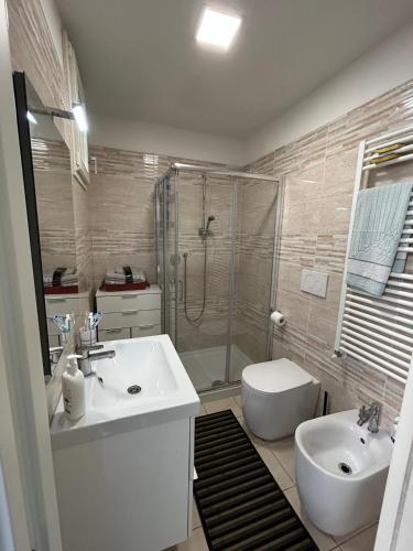 a bathroom with a sink and a shower and a toilet at Casa Raste in Rimini