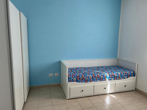 a bedroom with a bed with a blue wall at Casa Raste in Rimini