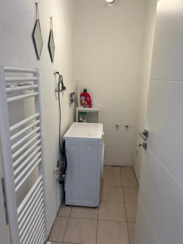 a small white laundry room with a washer and dryer at Casa Raste in Rimini