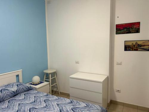 a bedroom with a bed and a table and a stool at Casa Raste in Rimini