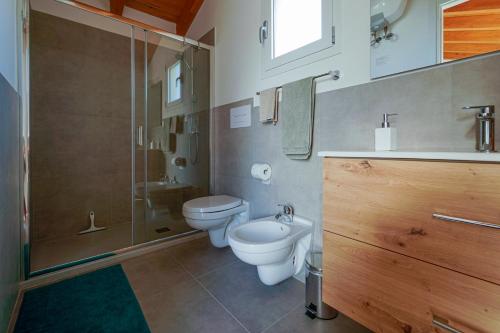 a bathroom with a toilet and a sink and a shower at Casa Selvaggio Blu in Santa Maria Navarrese