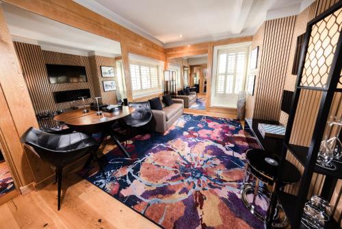 a living room filled with furniture and a rug at Quob Park Old House Hotel & Spa in Fareham