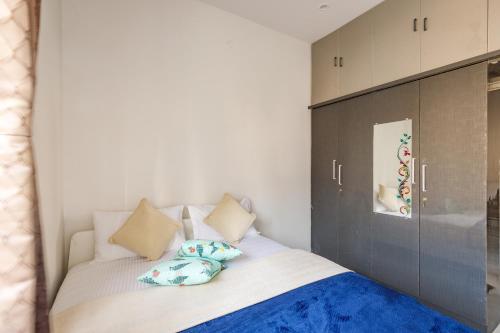 a bedroom with a large bed with pillows on it at Whispering Willows By Red Olive 3BHK Near Airport in Yelahanka