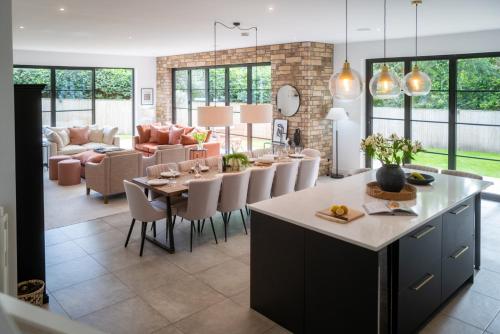 a kitchen and living room with a table and chairs at Verdant Rise - Contemporary Country Retreat in Albourne