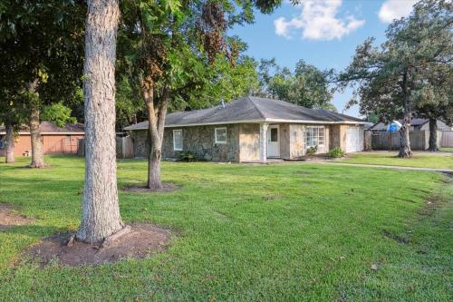 a house with trees in front of a yard at Charming 3 bedroom 2 bath home in Nederland in Nederland