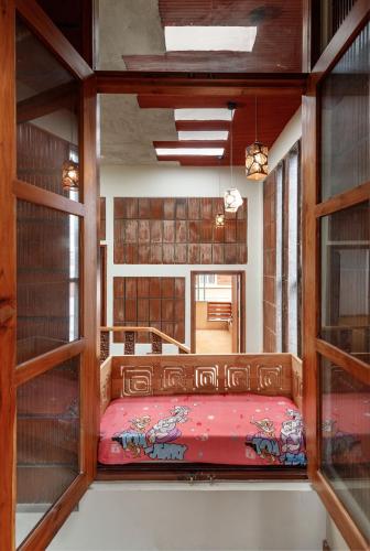 a bedroom with a bed in a room with shelves at Terrastone Duplex Spacious ApartmentNr Lake in Bengaluru