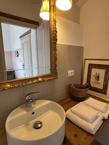 a bathroom with a sink and a mirror at La Valle degli Amici in Pianello Val Tidone