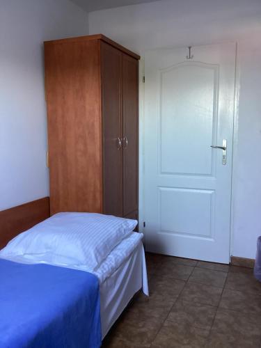 a bedroom with a bed and a closet and a door at Willa Rodzinna in Mielno