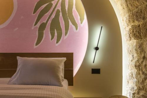 a bedroom with a bed and a clock on the wall at Beit Chams Sunrise Suite in Batroun in Batroûn