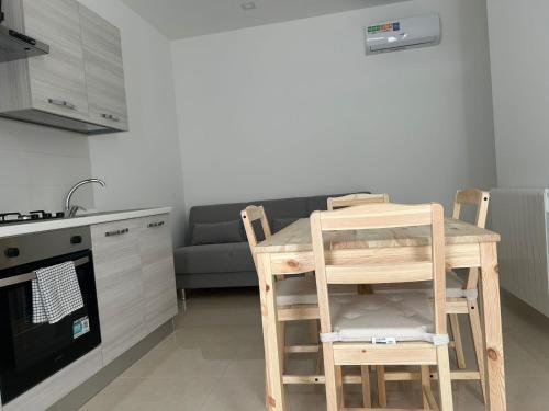 a kitchen with a table and chairs and a couch at CasaPrati in Grammichele