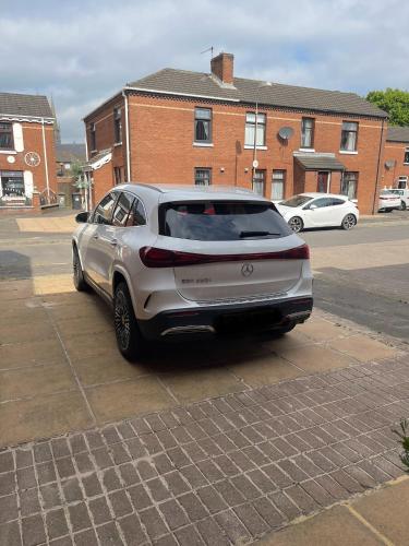 a silver car parked in a parking lot at Belfast Grand Central Living 5 Minutes Walk From Grand Central Station in Belfast