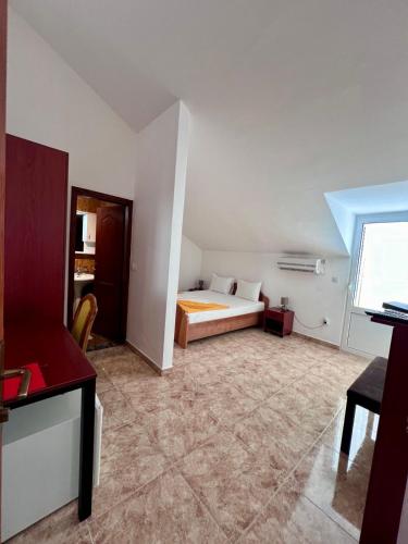 a hotel room with a bed and a desk at Hotel Max in Baošići