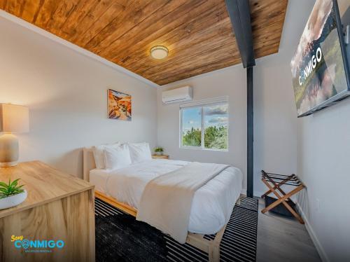 a bedroom with a bed and a wooden ceiling at Kanab Cube Shipping Cube Rental Experience in Kanab