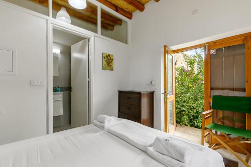 a bedroom with a bed and a sliding glass door at Annis House in Kato Lefkara