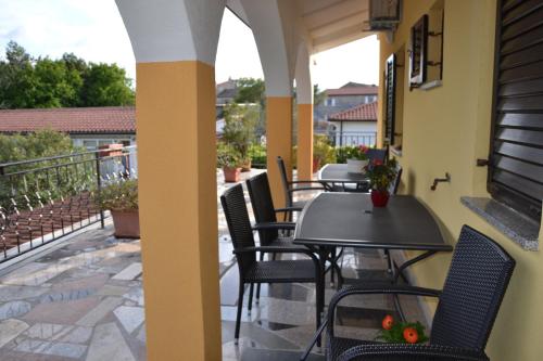 d'une terrasse avec des tables et des chaises sur un balcon. dans l'établissement Giorgina Apartments, à Umag