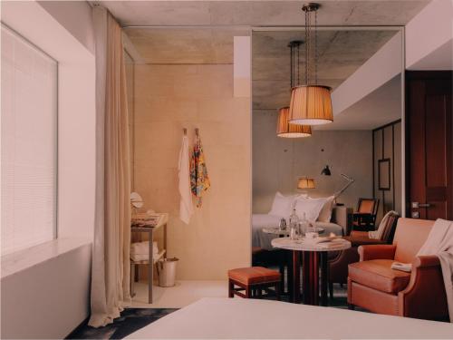 a hotel room with a bed and a table and chairs at Maison Heler Metz, Curio Collection By Hilton in Metz
