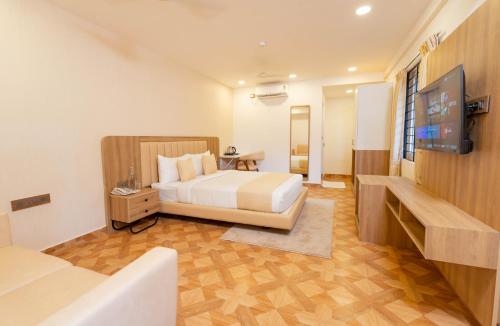 a bedroom with a bed and a flat screen tv at HZ Bangalore Stories in Bengaluru
