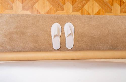 a pair of white shoes sitting on a floor at HZ Bangalore Stories in Bengaluru