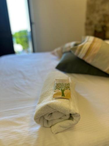 a towel sitting on top of a bed at Torre del Pardo Guest House in Sciacca