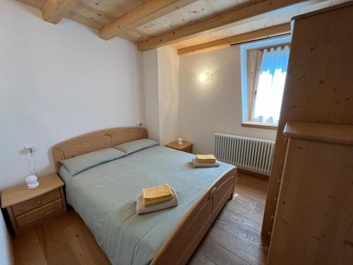 a bedroom with a bed with two boxes on it at Mountain Chalet Splazoi in Strembo