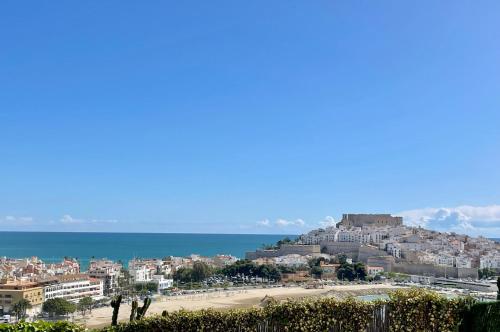 a view of a beach with buildings and the ocean at Mirador Somhome in Peñíscola
