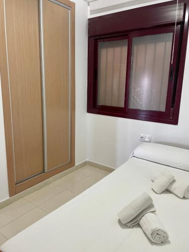 a bedroom with a bed with two towels on it at Mirador Somhome in Peñíscola