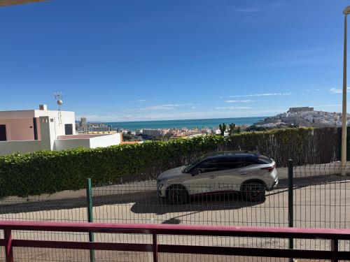 a car parked in a parking lot next to a fence at Mirador Somhome in Peñíscola