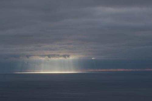 a beam of light in the clouds over the ocean at Quinta das Queimadas in Nordeste