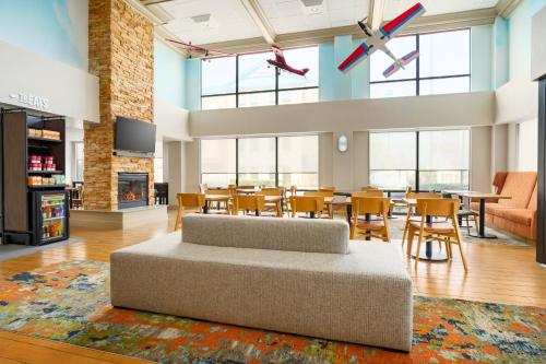 a large living room with a couch and tables and chairs at Hampton Inn Chicago-Midway Airport in Chicago