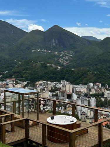 a wooden deck with a view of a city at LOFT Friburgo in Nova Friburgo