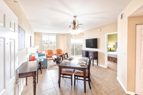 a living room with a table and chairs and a couch at Vacation Village at Parkway in Orlando