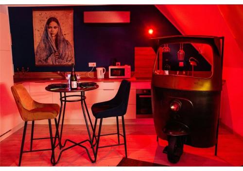 a room with a kitchen with a table and a stove at NÜ-DE GITES ET SPA in Zuydcoote