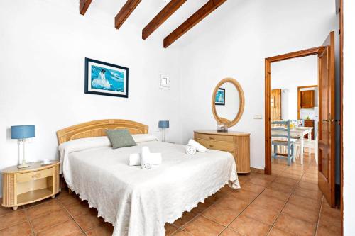 a white bedroom with a bed and a mirror at Villa Bini Anna by Villa Plus in Binibeca