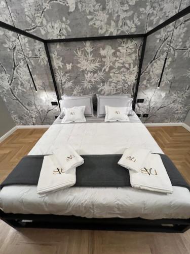 a bedroom with a large bed with white sheets and pillows at VillaSu Event Experience in Missaglia