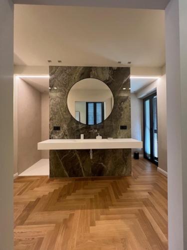 a bathroom with a sink and a mirror at VillaSu Event Experience in Missaglia