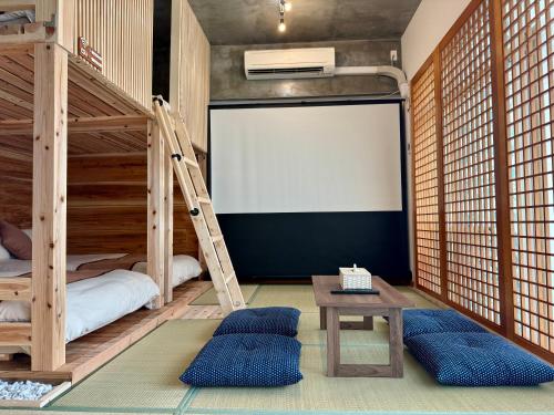 a room with two bunk beds and a white screen at New Open Japanese style with large bath in Ukaji