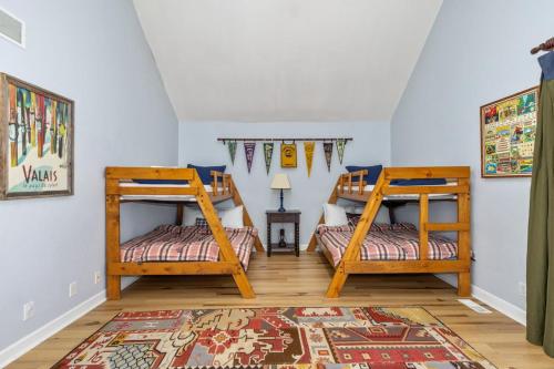two bunk beds in a room with a rug at Naples North in Fennville