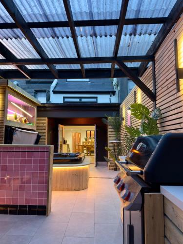 a building with a glass ceiling and a patio at Stylish City Centre Hideaway & Private Hot Tub in Galway