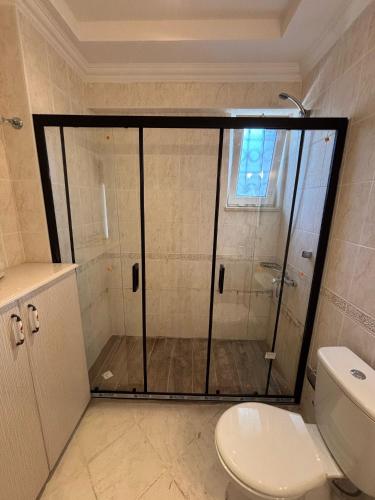 a bathroom with a glass shower with a toilet at Villa Xanthos 301 in Oludeniz