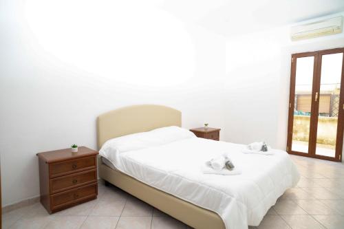 a bedroom with a bed and a dresser and a window at Elegante per 6 a due passi dalla spiaggia in Nettuno